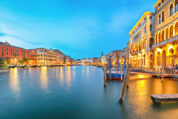 Amazing sunset and evening cityscape of Venice with famous Canal Grande and Rialto Bridge