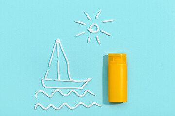 Drawings of sun and boat made with sunscreen cream on pale blue background