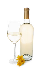 Bottle and glass of dandelion wine on white background