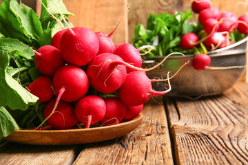 Plate with fresh radish on wooden background, closeup