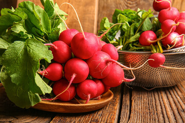 Plate with fresh radish on wooden background