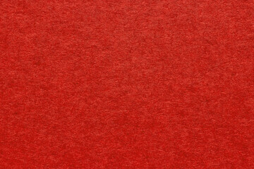 Fototapeta premium Red textured blank paper background close up. Vintage grainy background for design