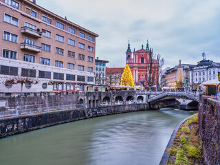 winding Ljubljana River,  colorful The Franciscan Church of the Annunciation houses and baroque buildings on the river bank, Slovenia