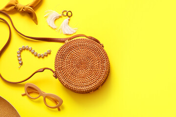 Stylish bag and different accessories on yellow background