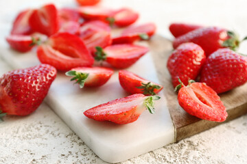 Board with fresh strawberries on white background