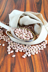 Brazilian bean. Carioca grains in a jute fabric on the rustic table.