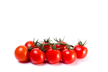 Branch of fresh cherry tomatoes with green stems isolated on white background. Clipping path.