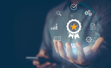 Fototapeta premium Standard quality assurance control certification business technology concept on virtual screen. Hand showing symbol quality assurance and standard, concept ISO certification of excellent service.