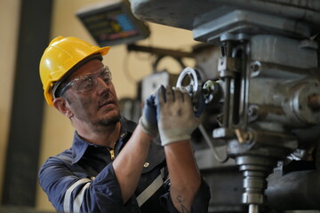 Robotics engineer working on maintenance of robotic arm in factory warehouse. Business technology.