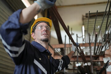 Robotics engineer working on maintenance of robotic arm in factory warehouse. Business technology.