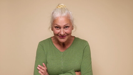 An elderly European woman confidently looks into the camera, smiling