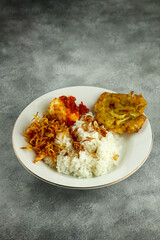 Nasi Uduk is an style steamed rice cooked in coconut milk usually eaten with side dishes of tempeh, vermicelli, eggs, and spicy potatoes, This food is typical food from Jakarta .