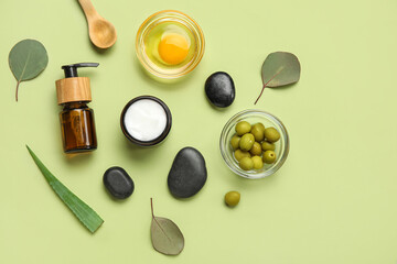 Composition with natural cosmetics, ingredients and spa stones on color background