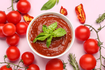 Bowl of delicious tomato sauce and ingredients on lilac background