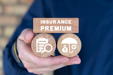 Man holding wooden blocks with inscription: INSURANCE PREMIUM. Insurance premium business service concept. Insure of money, health, life, car, house.
