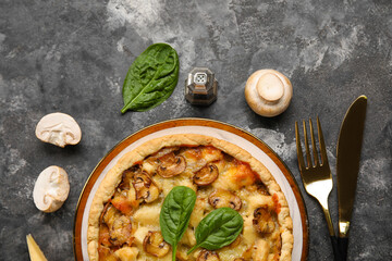 Mushroom pie with spinach leaves and champignons on dark grey grunge background
