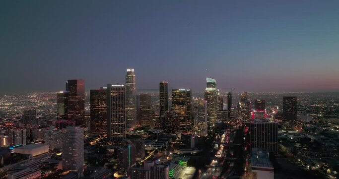 Scenic aerial view of skyscrapers in Los Angeles city at night. Illuminated buildings in Los Angeles skyline, Aerial drone shot, Los Angeles, California. Skyline towers in LA.
