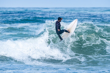 Surfer riding waves in Furadouro Beach