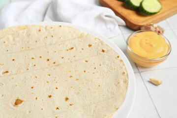 Plate with fresh lavash on table, closeup