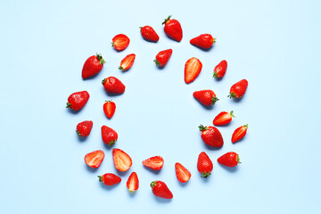 Frame made of fresh strawberries on blue background