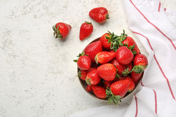 Bowl of fresh strawberries on white background