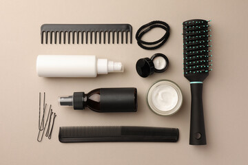 Flat lay composition with brush, combs and different hair products on light grey background