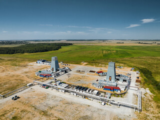 Fototapeta premium Huge construction site for building new mine by green fields