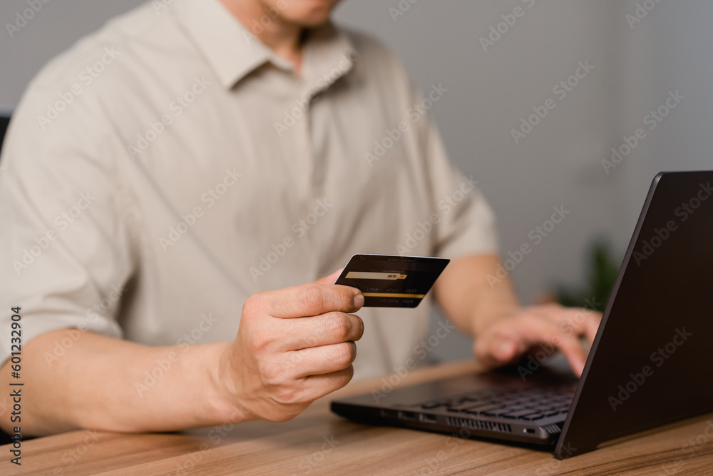 Poster adult man using laptop to register via credit card to shop online. credit card secure online shoppin