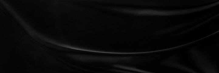 Black gray satin dark fabric texture luxurious shiny that is abstract silk cloth panorama background with patterns soft waves blur beautiful.