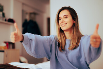 Happy Woman Holding Thumbs-up Smiling at Home. Cheerful tenant enthusiastic about the agreement 
