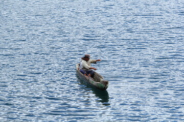 person in a boat and fishing on the laut tawar lake