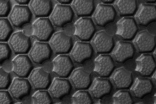 close-up view of sole of shoe pattern, abstract of black rubber texture, grooves surface bottom of footwear for traction and grip on surfaces in full frame, macro background or wallpaper for designing