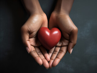 Hands holding a heart.