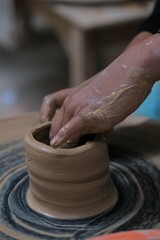 he process of making tableware product from clay. Craftman work at workshop. Pembuatan mangkok dan gelas dari tanah liat