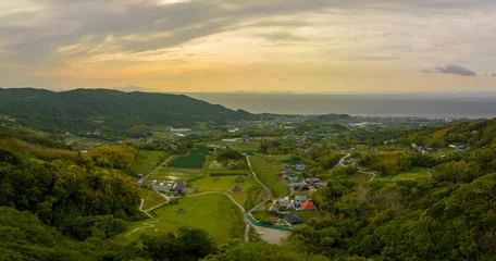 Vlies Fototapete Reisfelder Panoramic aerial view of green fields and thatched huts in coastal landscape