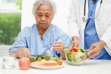 Asian Nutritionist holding healthy food for patient in hospital, nutrition and vitamin.