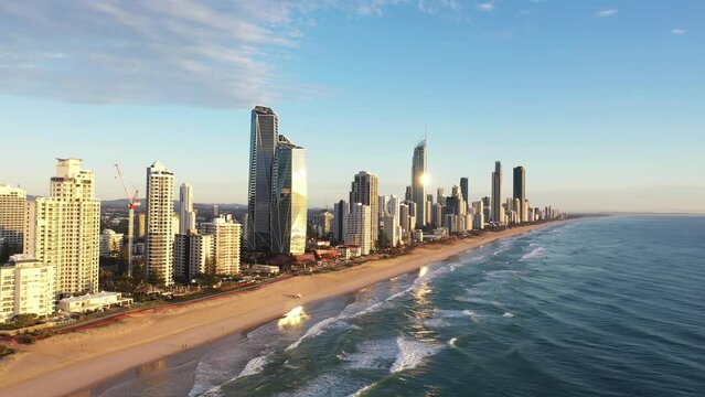 Aerial fly across Surfers Paradise coastline at sunrise. Gold Coast Australia