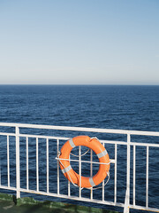 Life belt at the ship railing and views to empty ocean