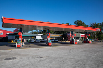 Fuel petrol gas diesel station red canopy bowser refill convenience retail store shop