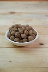 selective focus to Pile of raw brown tapioca pearls for bubble tea on white bowl. soft focus