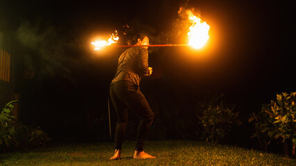Man performs a fire dance spinning in Hawaii