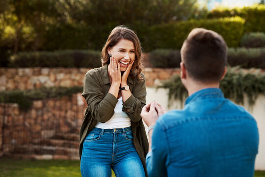 Love, surprise and engagement with couple in nature for wedding, commitment and happiness. Smile, proposal and offer with man and woman in backyard of home for marriage, wow and save the date