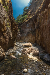 Fototapeta na wymiar vertical shot of a landscape of a rocky canyon and the river bed on a hot sunny day in the province of Puntarenas in Costa Rica