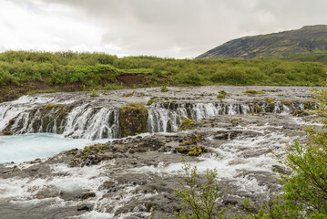 Side view on Bruarfoss waterfall in the south of Iceland. Hike, trail, hiking, powerful, clear, pure, unpolluted, magical, wonderful, icelandic rivers