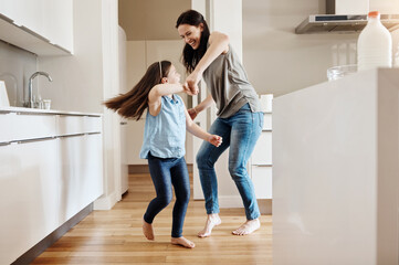 Happy, dance and a child with a mother in the kitchen, bonding and quality time together. Smile,...