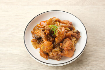 Ayam Goreng Mentega or Butter Chicken in white plate. Indonesian food.
