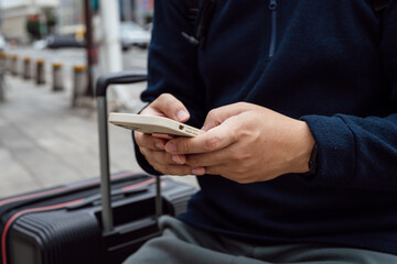 Man in downtown city street ordering taxi using smart phone app Booking taxi using application online on smart phone