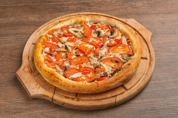 Fresh classic pizza with tomato sauce, mozzarella, spicy chorizo, bell pepper on a wooden background