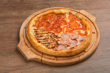 Fresh classic pizza with tomato sauce, mozzarella, spicy chorizo, bell pepper on a wooden background