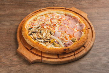 Fresh classic pizza with tomato sauce, mozzarella, spicy chorizo, bell pepper on a wooden background